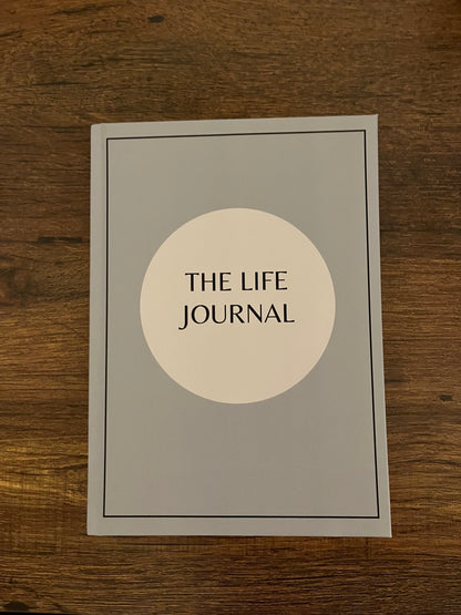 A5 Hardback Grey and Blue edition The Life Journal, background on a table